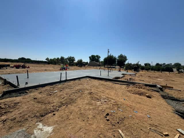 Foundation forms and rebar laid out on a graded building lot