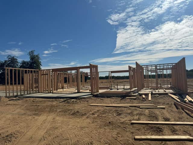 Wall framing going up on the slab of a new single story home