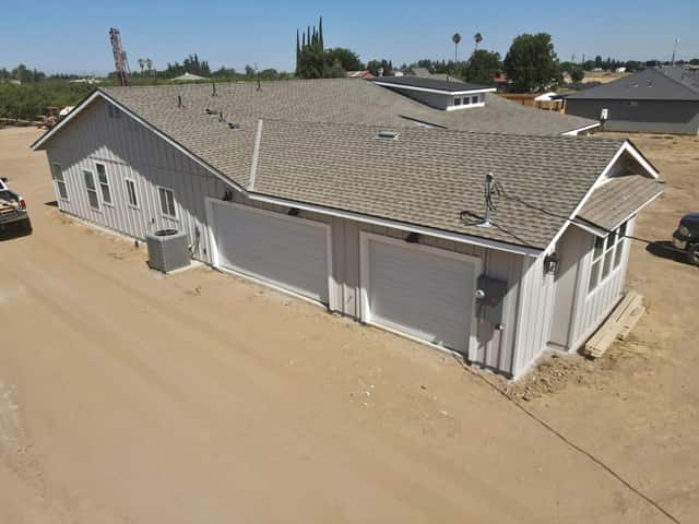 Elevated view of the finished roof and attached garage on a new custom home