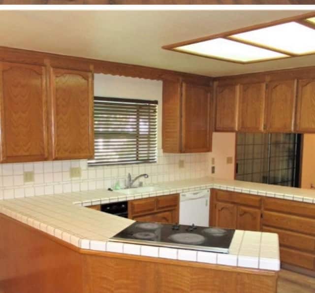 Original oak cabinet kitchen with tile countertops, photographed before an Almond Grove Homes remodel