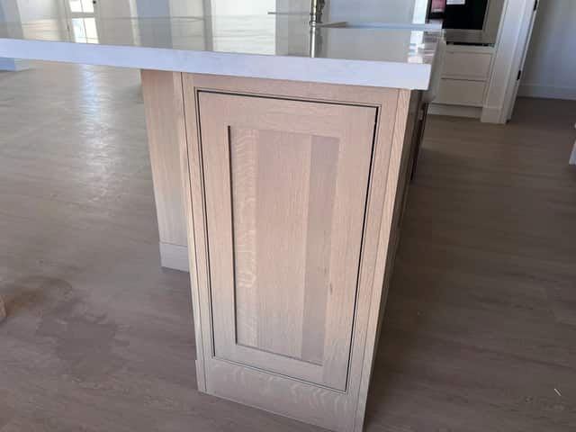 Waterfall edge detail on a light oak kitchen island
