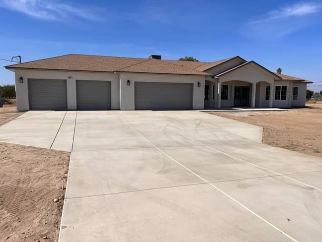 Completed single story home with a three car garage and a new concrete driveway. Opens our modular and production homes page.