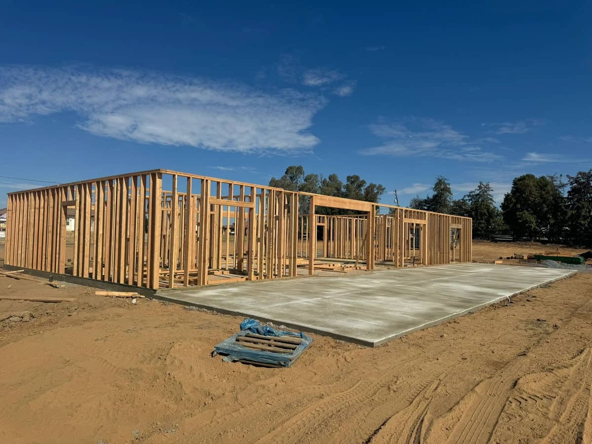 Framing progress across the full slab of a new custom home